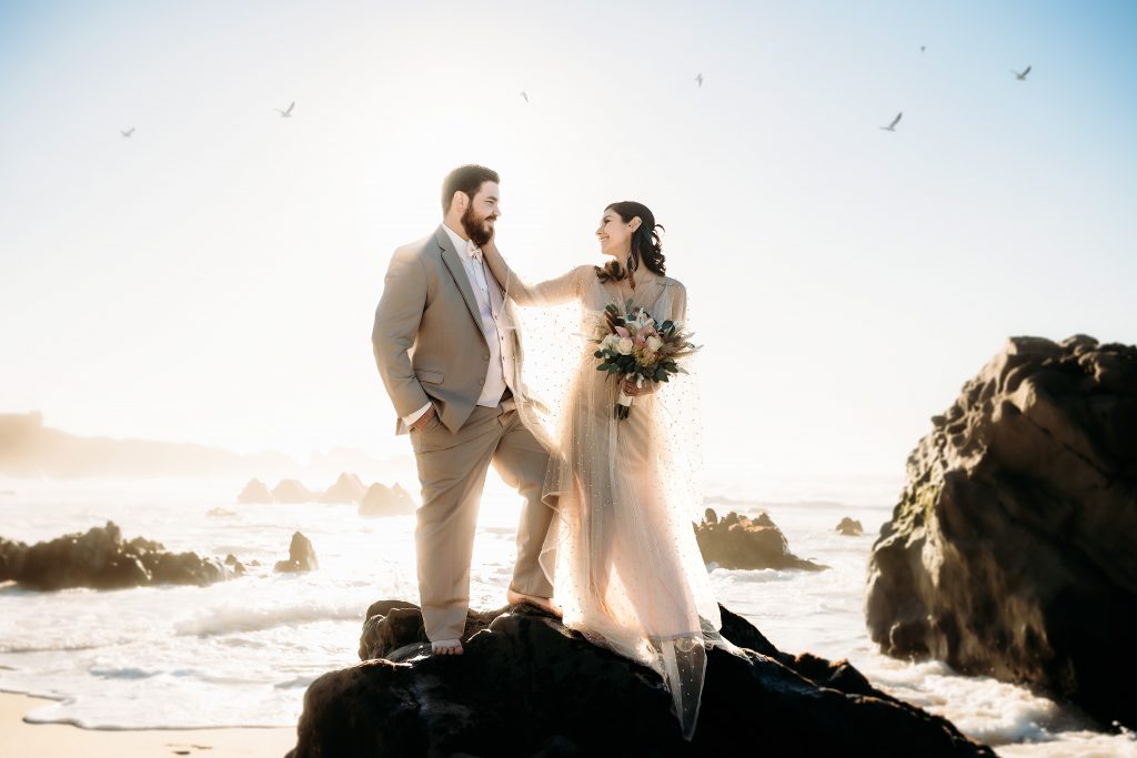 Couple on the rocks at the beach in Big Sur